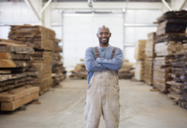 Man in overalls in a lumber yard