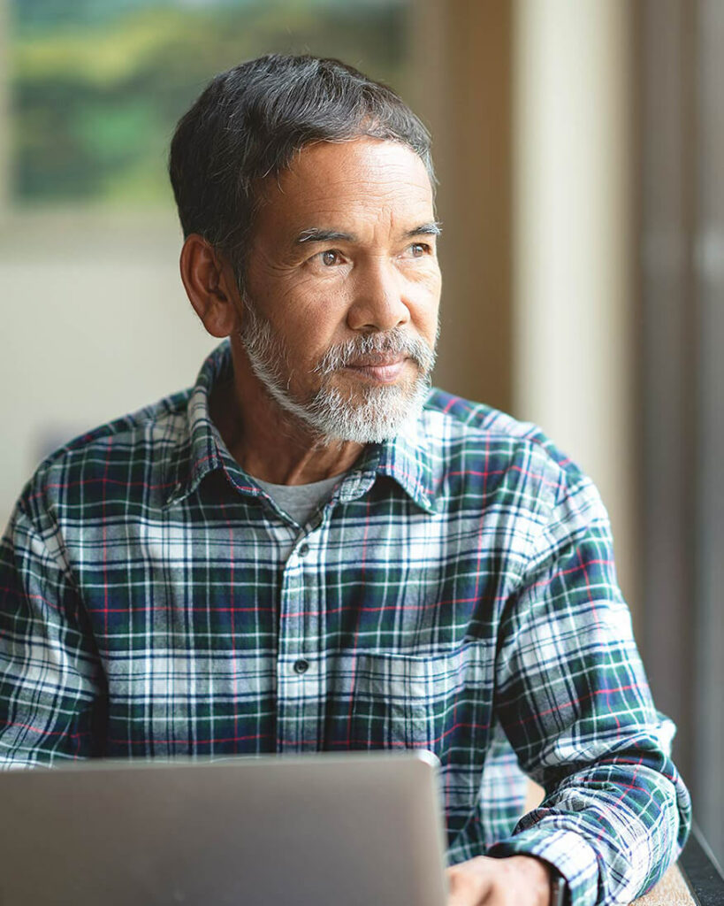 Older man working on laptop