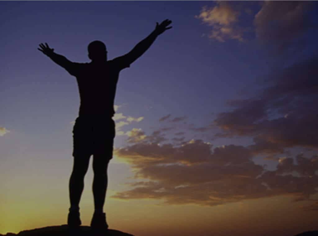 Person looking at the sky with out stretched arms